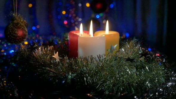New Year's Candles , and Christmas Decorations. Blurred Background with Colored Lights