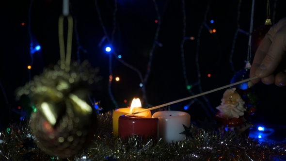 Ignition of New Year's Candles, a Long Match On the Eve of Christmas Home Holiday.
