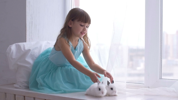 Pretty Teen Girl Having Fun, Hugging and Playing with Decorative Rabbit