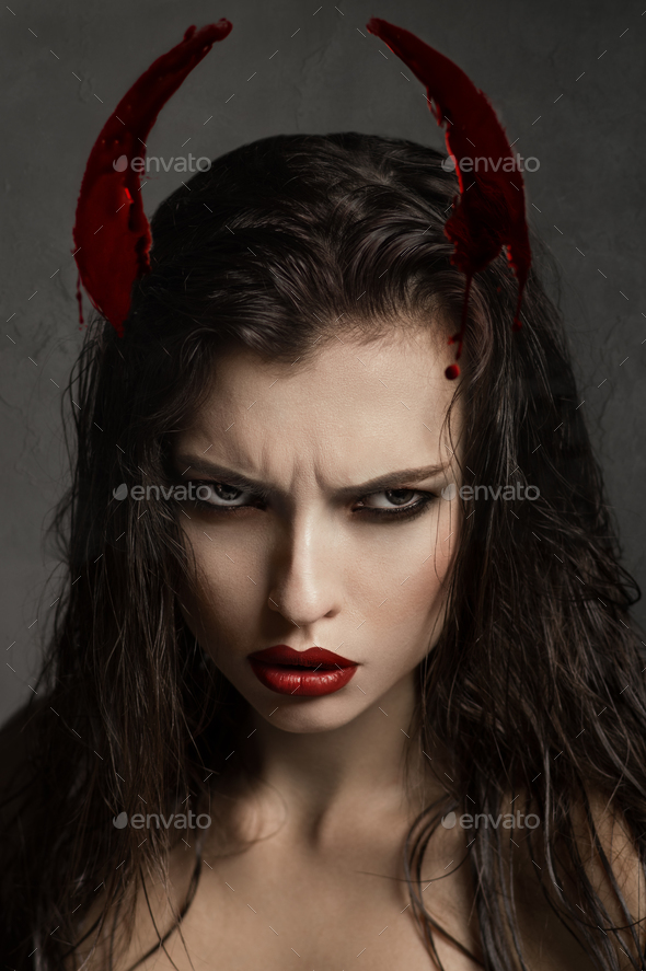 Brunette model with devil horns
