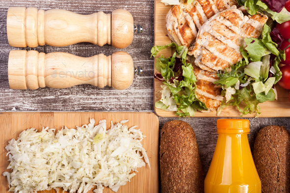 Delicious grilled chicken on wooden board - Stock Photo - Images