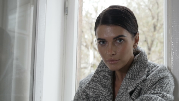 Woman Sitting on Window