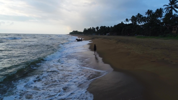 Aerial of the Girl Who Walks Along at the Sandy Beach at Sunset in Sri Lanka