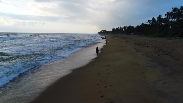 Aerial of the Girl Who Walks Along at the Sandy Beach at Sunset in Sri Lanka