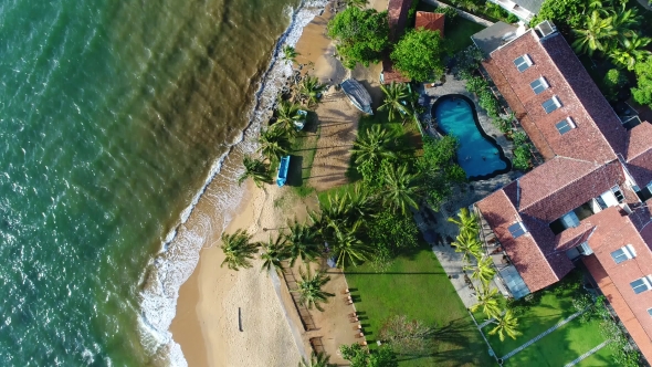 Aerial View in Motion of Houses with Swing Pool Near the Beach in Sri Lanka