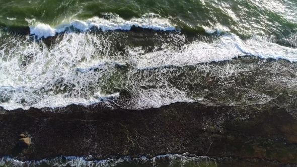Aerial View From the Top of Sea Waves That Break Down on the Rocky Ledge in the Sea in Sri Lanka