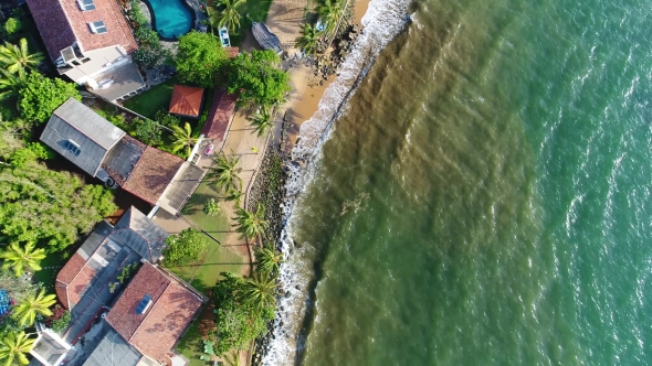 Aerial Top Shot in Motion Houses with Swing Pool Near the Sandy Beach in Sri Lanka