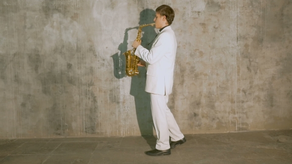 A Musician in a White Suit Plays the Saxophone