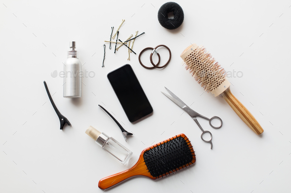 smartphone, scissors, brushes and other hair tools - Stock Photo - Images