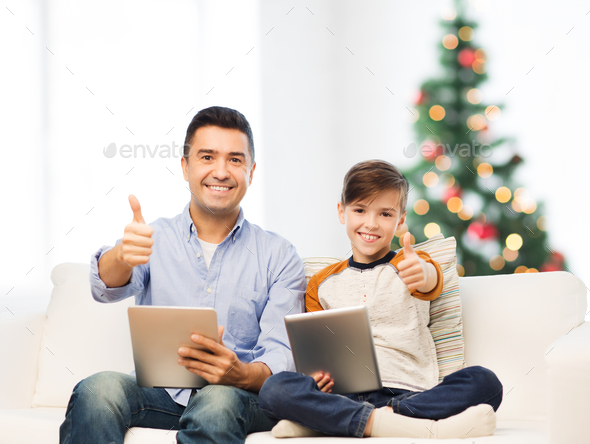 father and son with tablet pc showing thumbs up