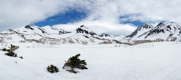 Panorama Snowy Rocky Mountain And White Clouds On Blue Sky Stock Photo By Kamchatka