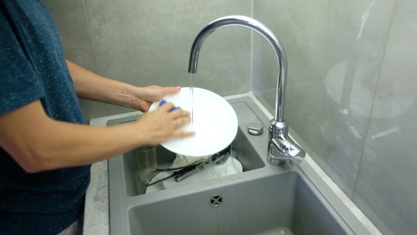 Man Washing Dirty Dishes