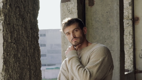 Portrait of Passionate Look at Camera of Handsome Man Leaned on His Hand alt