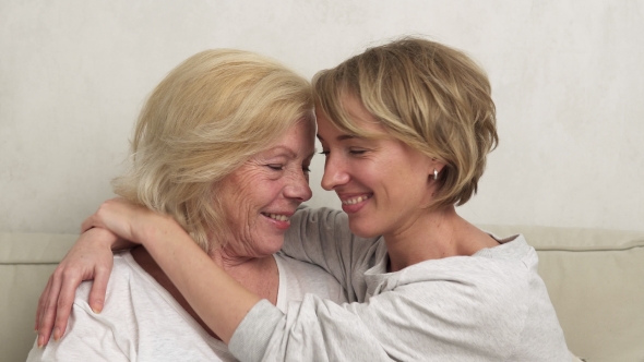 Close-up of a Happy Daughter and Old Mother Hugging and Smiling