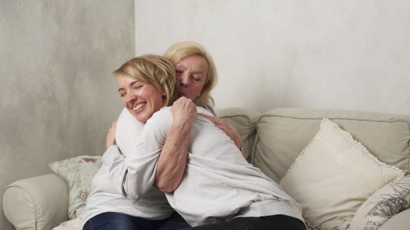 Happy Old Mother and Adult Daughter Holding Hands and Hugging