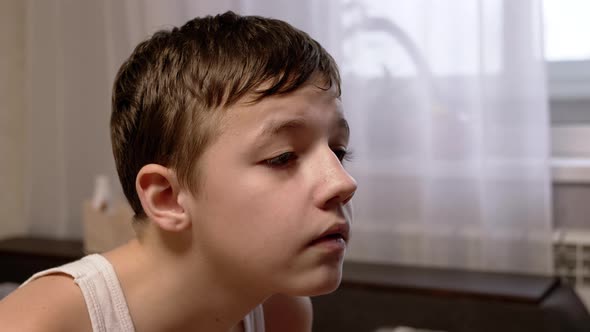 A Face of a Serious Child Carefully Looking at the Monitor Screen alt