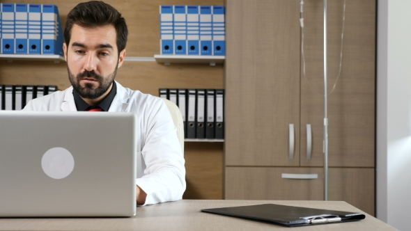 Doctor in His Office at the Laptop alt