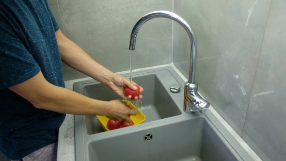 Man Washes Tomatoes