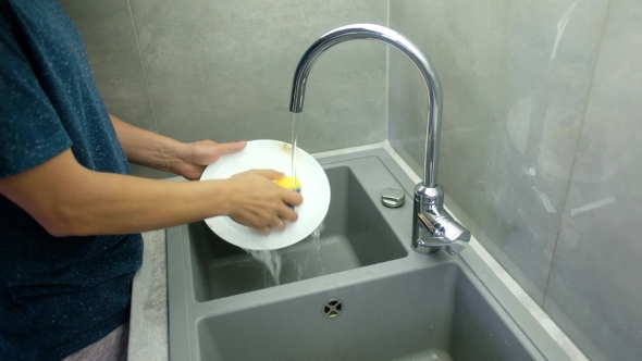 Man Washing Dirty Dishes