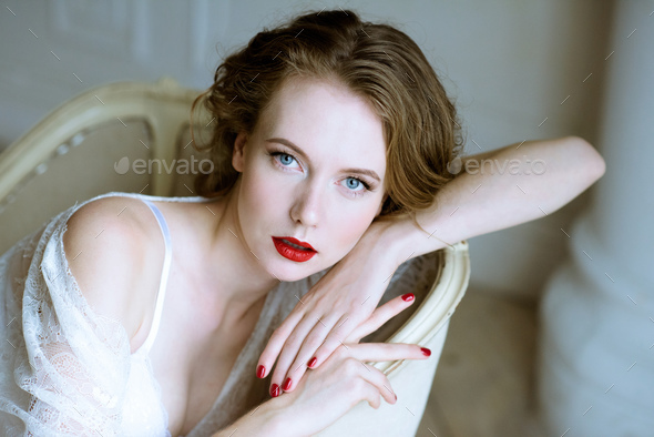Fashionable female portrait of cute lady in white robe indoors - Stock Photo - Images