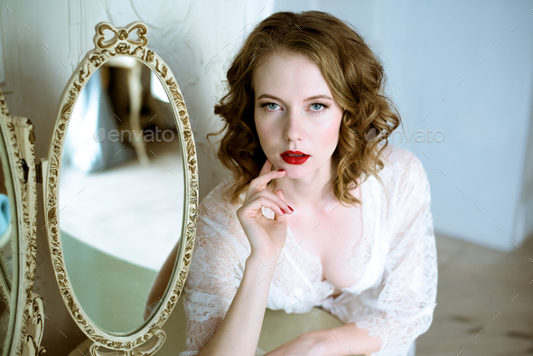 Fashionable female portrait of cute lady in white robe indoors - Stock Photo - Images