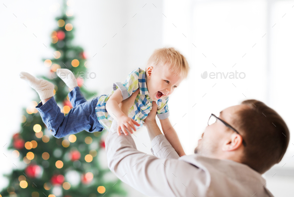 happy father playing with son at christmas - Stock Photo - Images