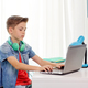 boy with headphones typing on laptop at home - PhotoDune Item for Sale