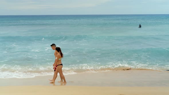 Couple walking together on the beach 4k