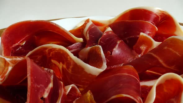 Jamon on the plate. Shooting in motion. alt