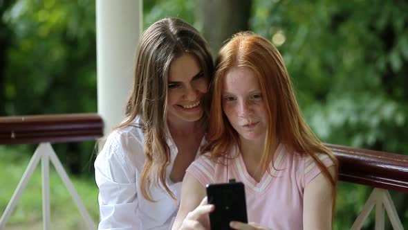 Young Women Taking Selfie Using the Phone