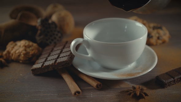 Cup of Hot Chocolate, Cinnamon Sticks, Cookies and Chocolate on Wooden Table