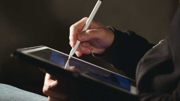 Designer Drawing and Scaling On His Tablet Using Stylus