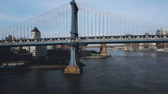 Aerial View of the Manhattan Bridge Through the East River in New York, America. Drone Flying Along alt
