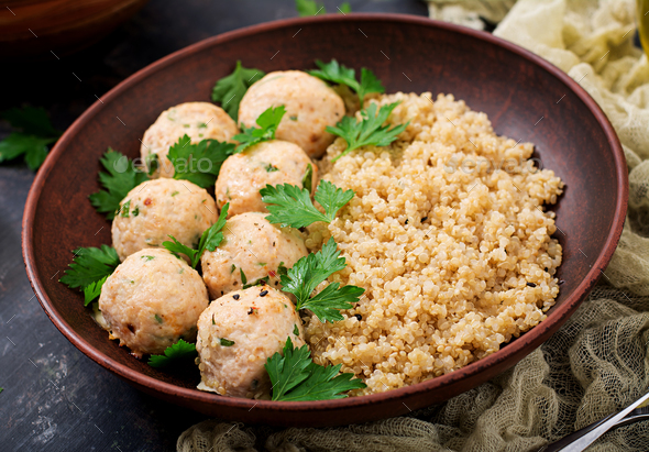 Baked meatballs of chicken fillet with garnished with quinoa - Stock Photo - Images