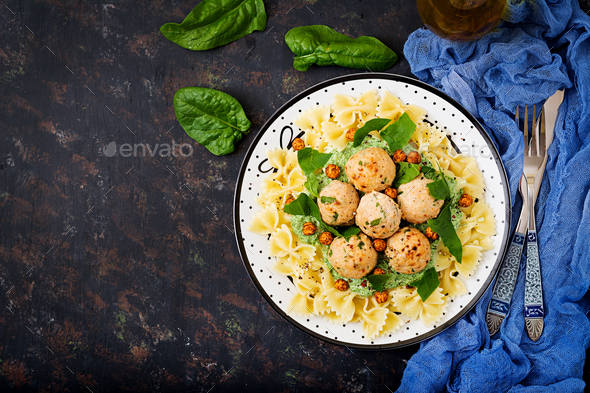 Farfalle pasta with meatballs and spinach sauce with fried chickpeas - Stock Photo - Images