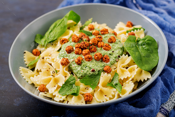 Vegan Farfalle pasta with spinach sauce with fried chickpeas.