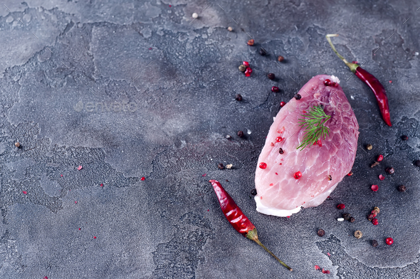 Raw fresh meat steak entrecote and seasonings in the iron plate with oil, chili, spices dill - Stock Photo - Images