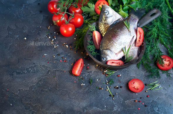 Delicious fresh fish on dark vintage background. - Stock Photo - Images