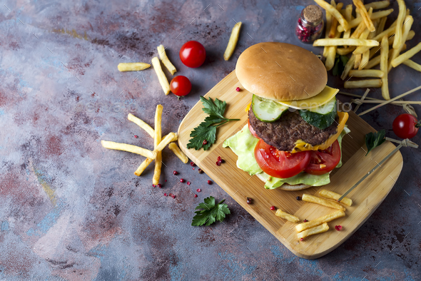 Hamburger with french fries, beer on a stone table - Stock Photo - Images
