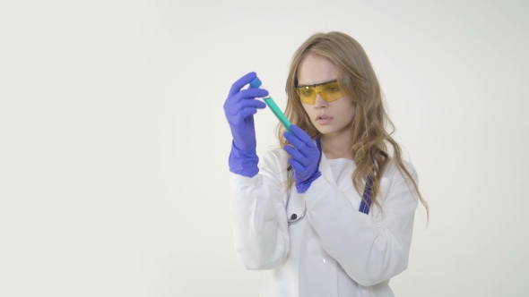Female Scientific Researcher or Doctor Looking at a Test Tube