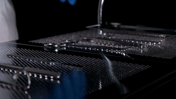 the Surgeon Prepares the Syringe on the Table with the Tools for the Operation alt