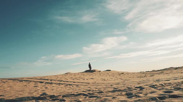 Young Woman Walking in Desert Landscape