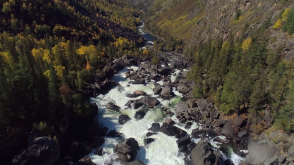 Aerial Flight Over Steam Raging River and Waterfall in Autumn Forest and Valley