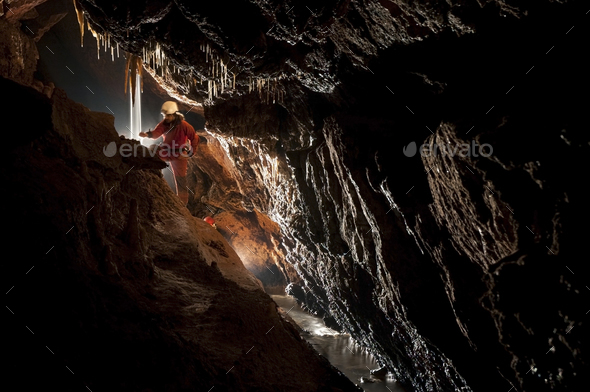 Cave explorer, speleologist exploring the underground - Stock Photo - Images