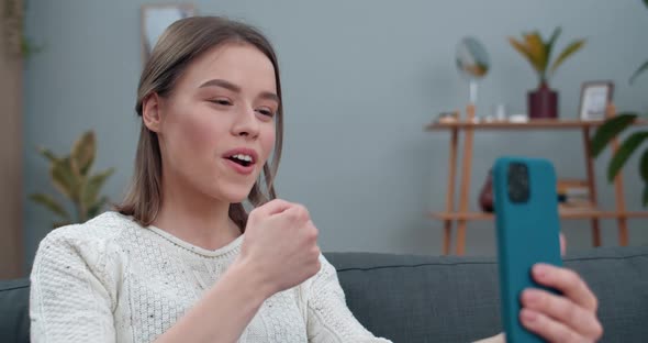 Close Up View of Deaf Woman Having Video Conversation and Showing with Sign Language Phrase Go for alt