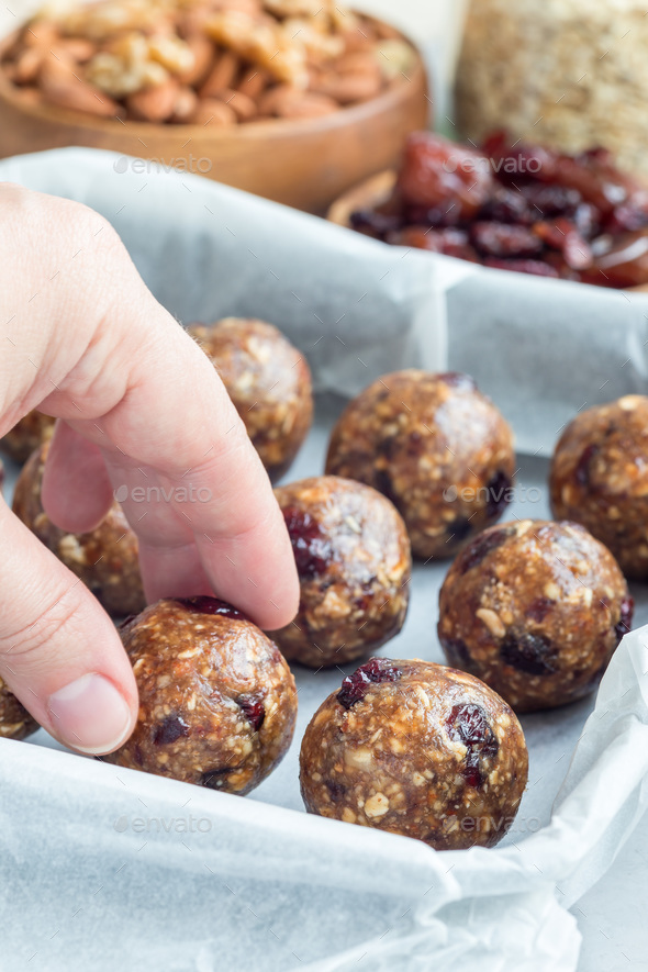 Healthy energy balls with cranberries, nuts, dates and rolled oats on