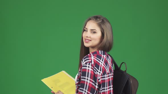 Gorgeous Cheerful Female Student Smiling Over Her Shoulder alt