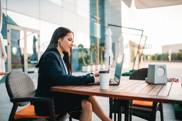 Business woman works on laptop in office - Stock Photo - Images