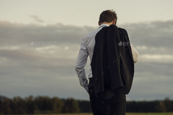 Downhearted businessman standing outdoors - Stock Photo - Images
