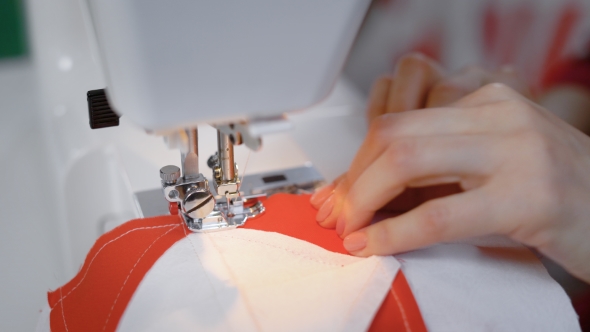 Shot of Woman's Hands Working on a Sewing Machine alt